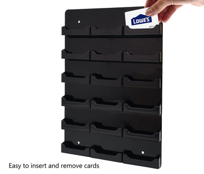Eighteen Pocket Wall Business Card Rack Holder Vertical Hanging black  on black with a business card and a hand