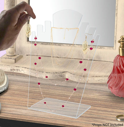 Clear earring holder for necklaces and earrings and bracelets with a jewelry set on a desk and a hand