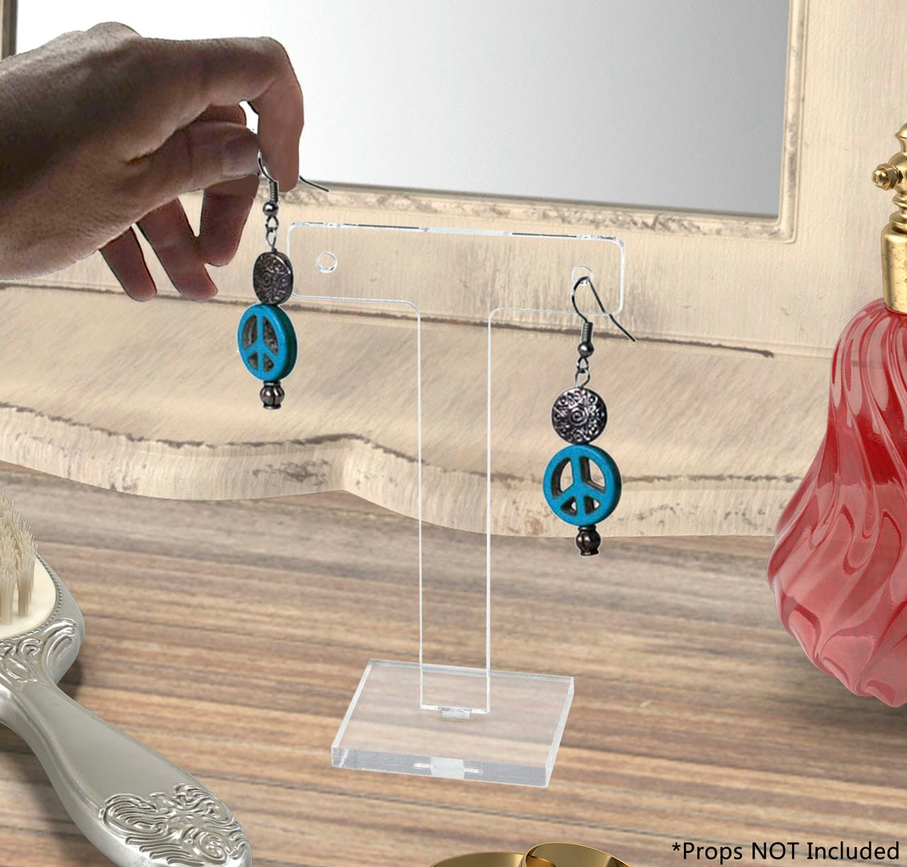 Ear bar small earring holder with earrings and hand on a vanity